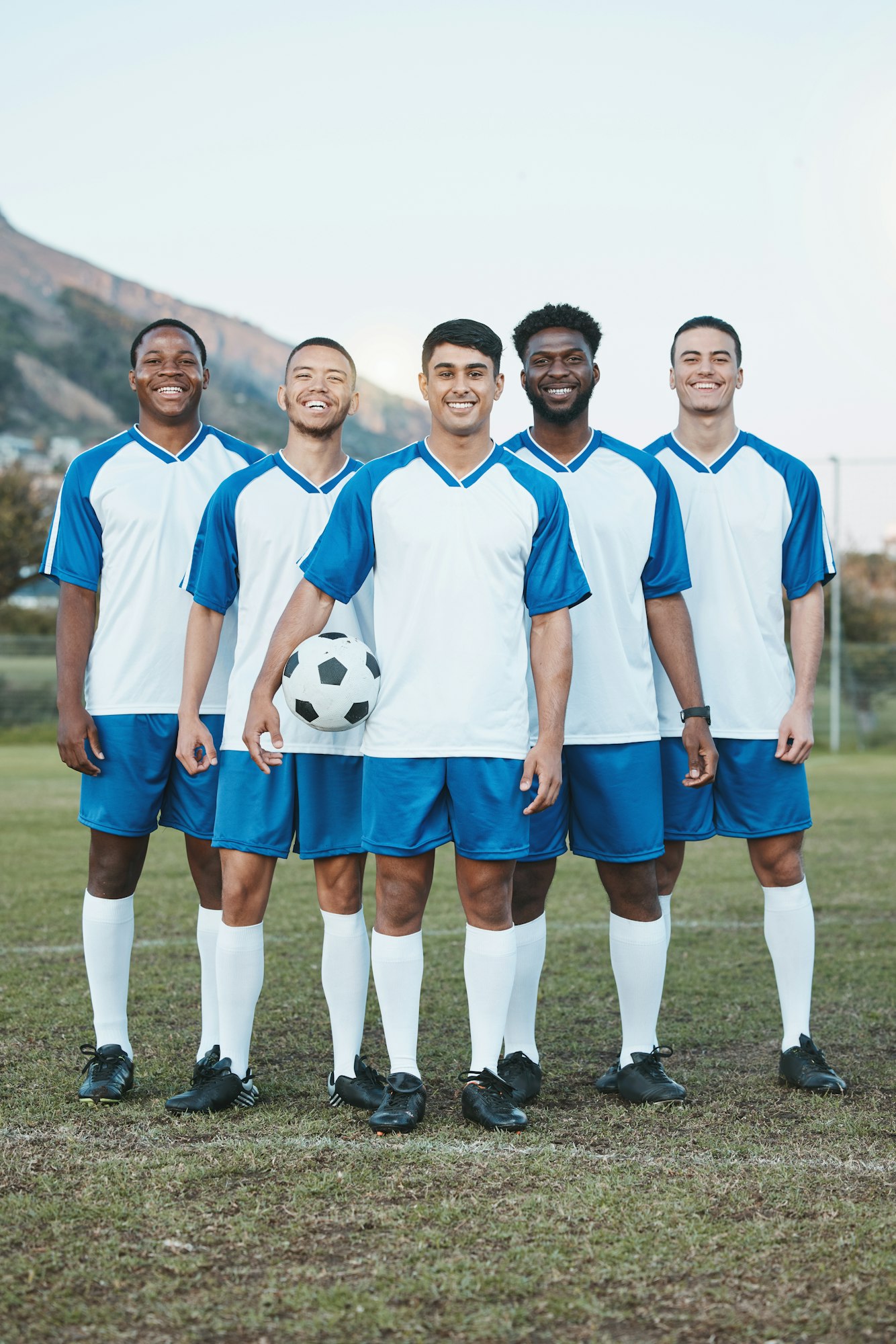 Team, soccer ball and portrait of sports group on field for fitness training or game outdoor. Footb